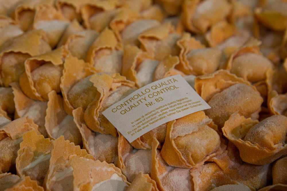 Artisan ravioli with a quality control label, discarded at a food waste facility