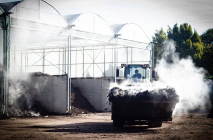 A loader moving steaming compost at the Lavigny food waste treatment facility, photo by Natalia Krylova